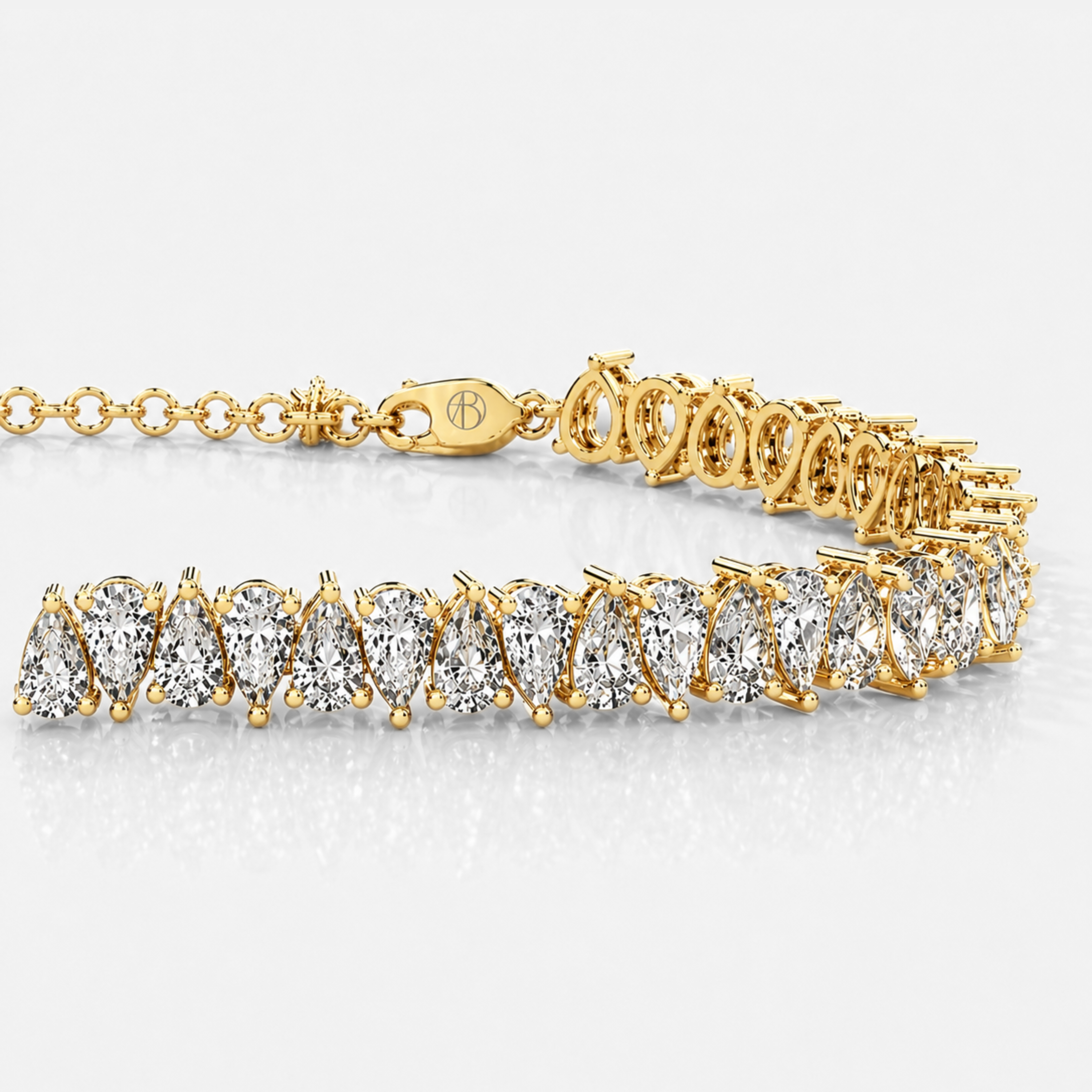 Detailed view of pear cut diamonds in yellow gold tennis bracelet