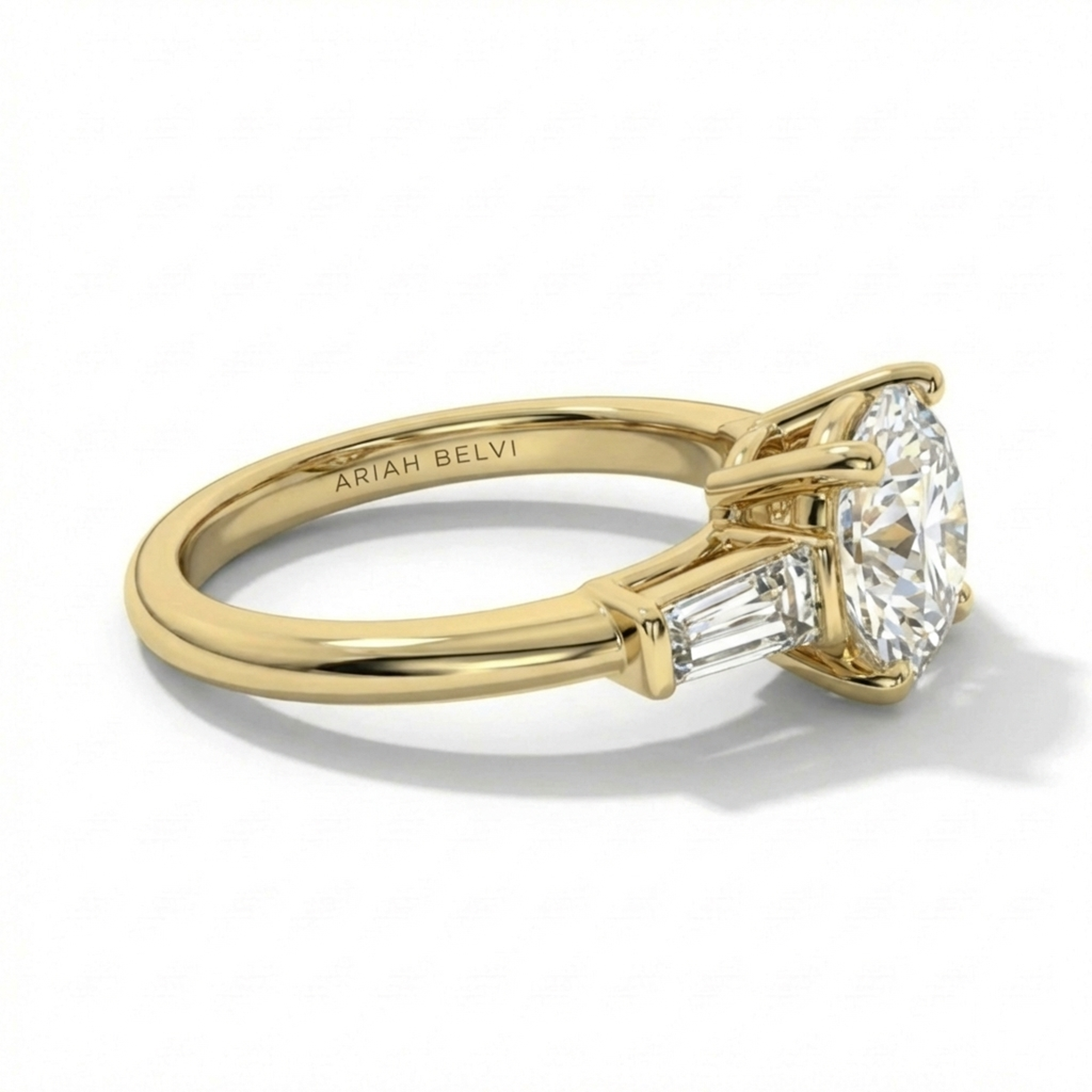 ARIAH BELVI round diamond trilogy engagement ring in yellow gold showing side profile and setting detail