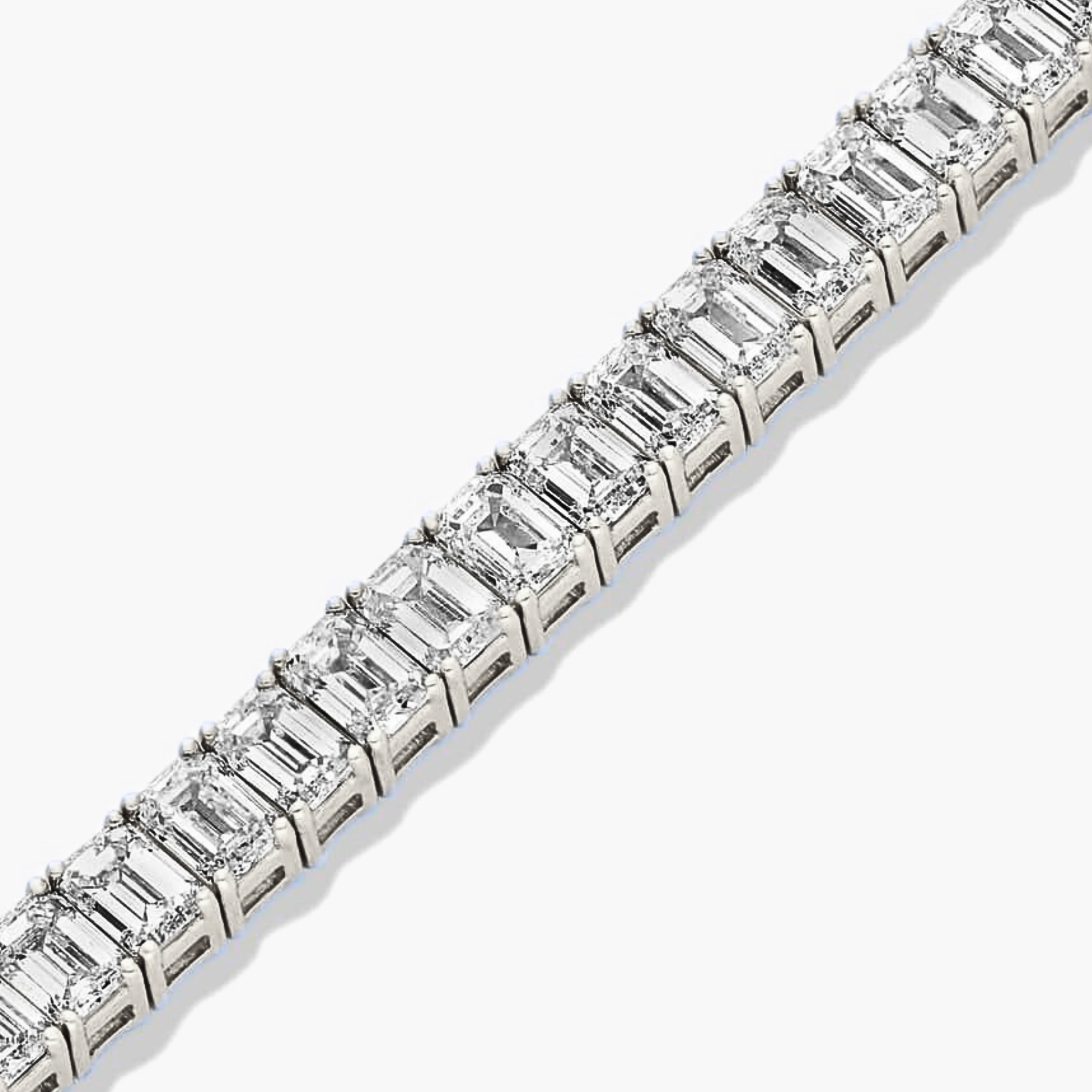 Close-up view of emerald cut diamond tennis bracelet in white gold