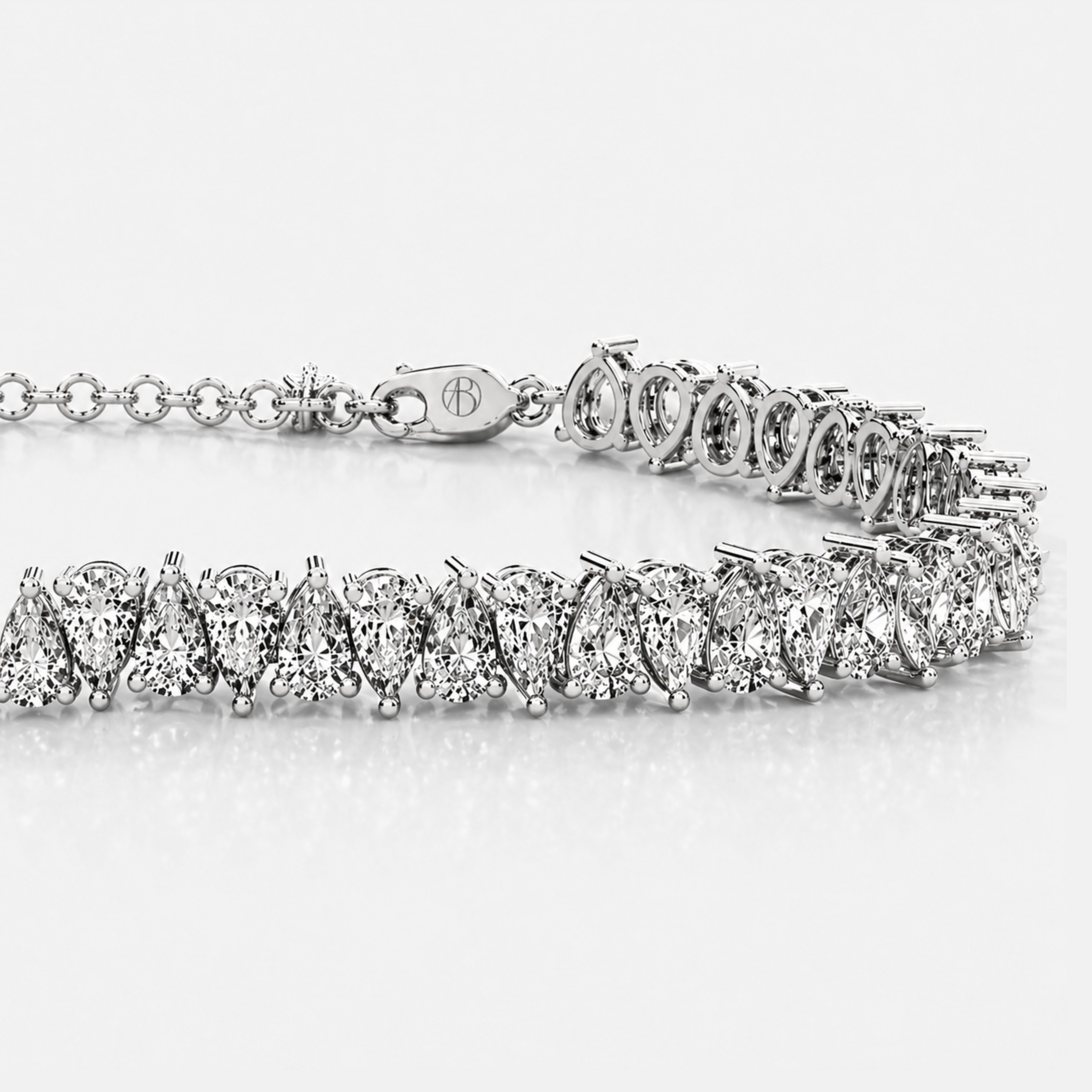 Detailed view of pear cut diamonds in white gold tennis bracelet