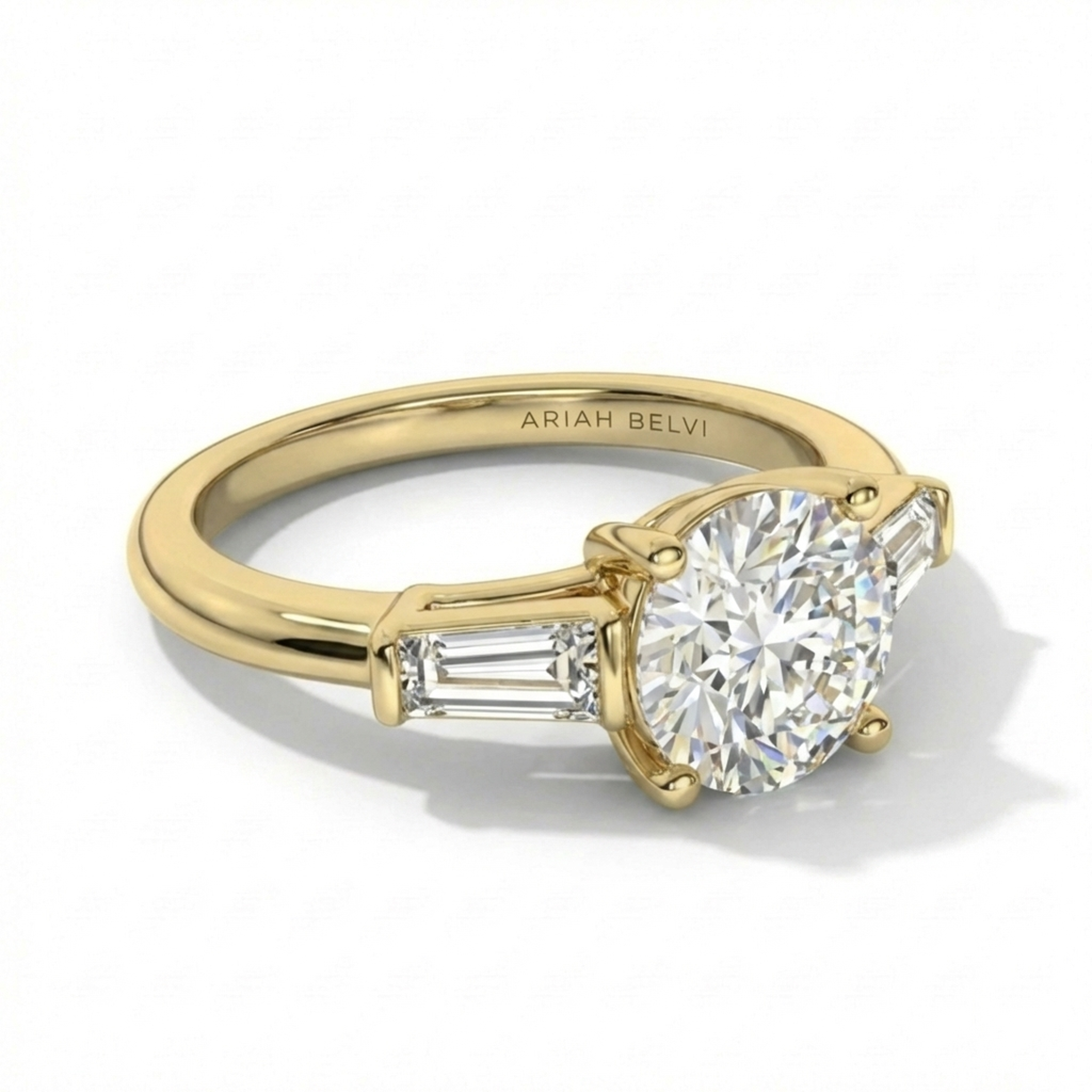 ARIAH BELVI round diamond trilogy engagement ring in yellow gold with tapered side stones, 3/4 angle view